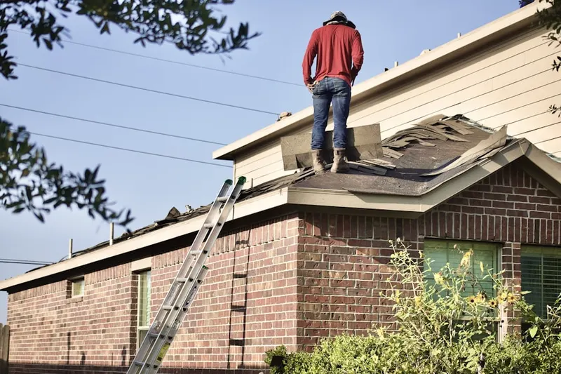 Professional roofer working on a residential roof in Del Monte Village